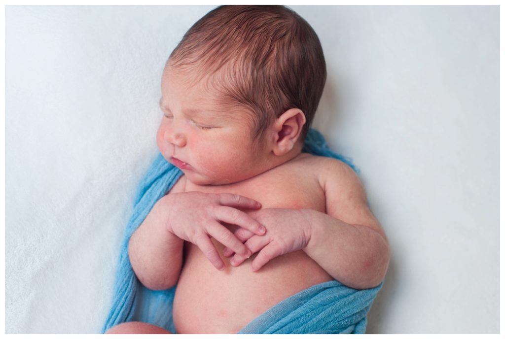 Graham Newborn laying on white blanket