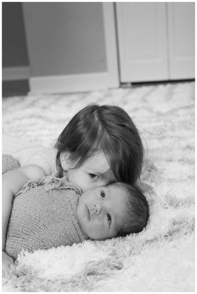 Graham Newborn sister giving kisses