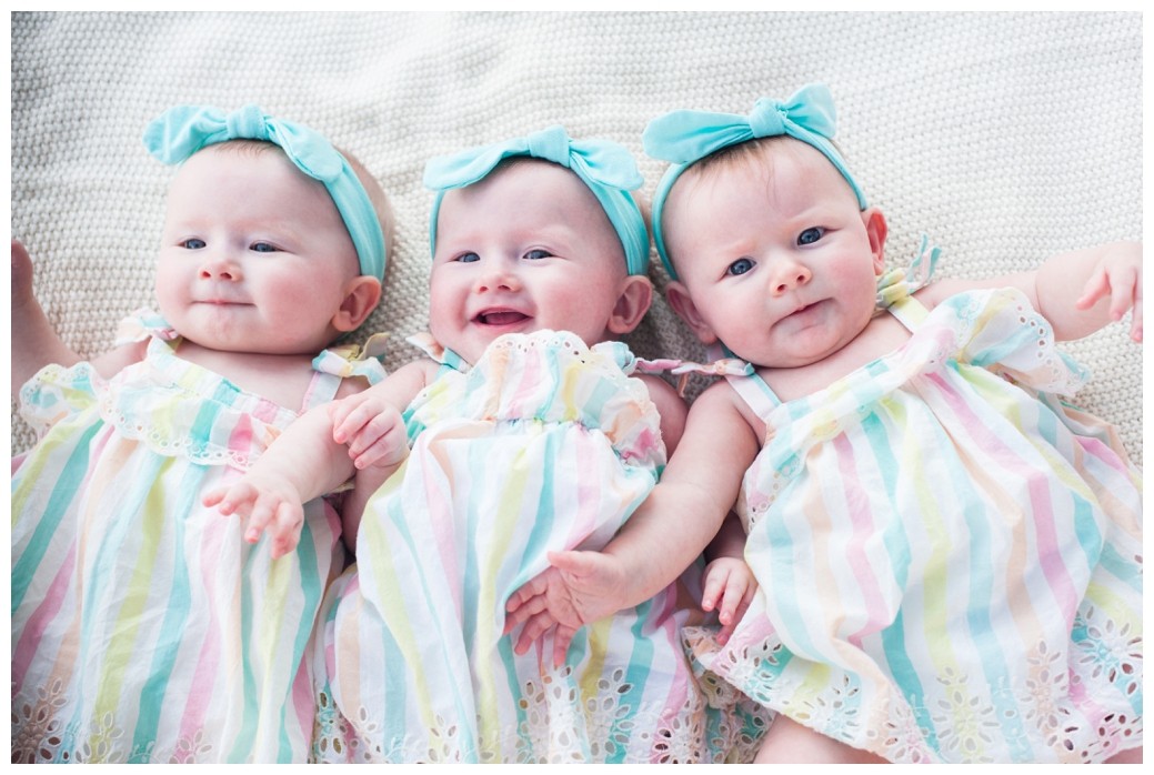 The Marlar Triplets girls laying on blanket