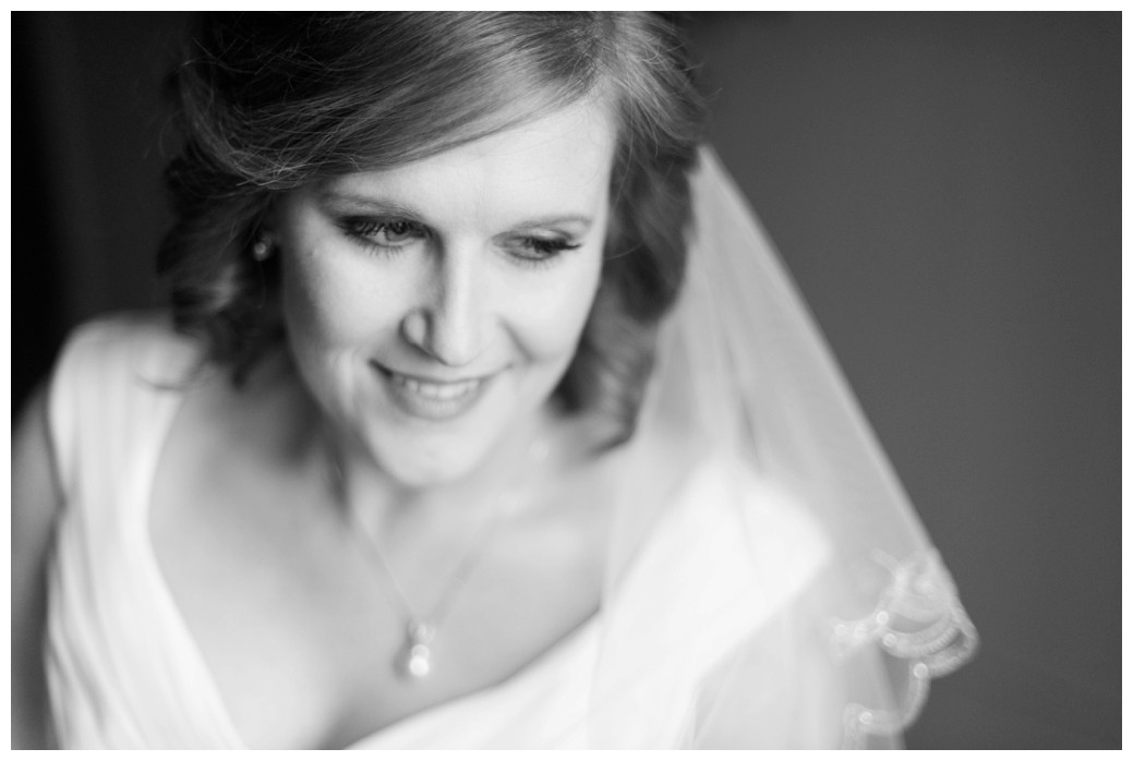 bride looking out window in black and white