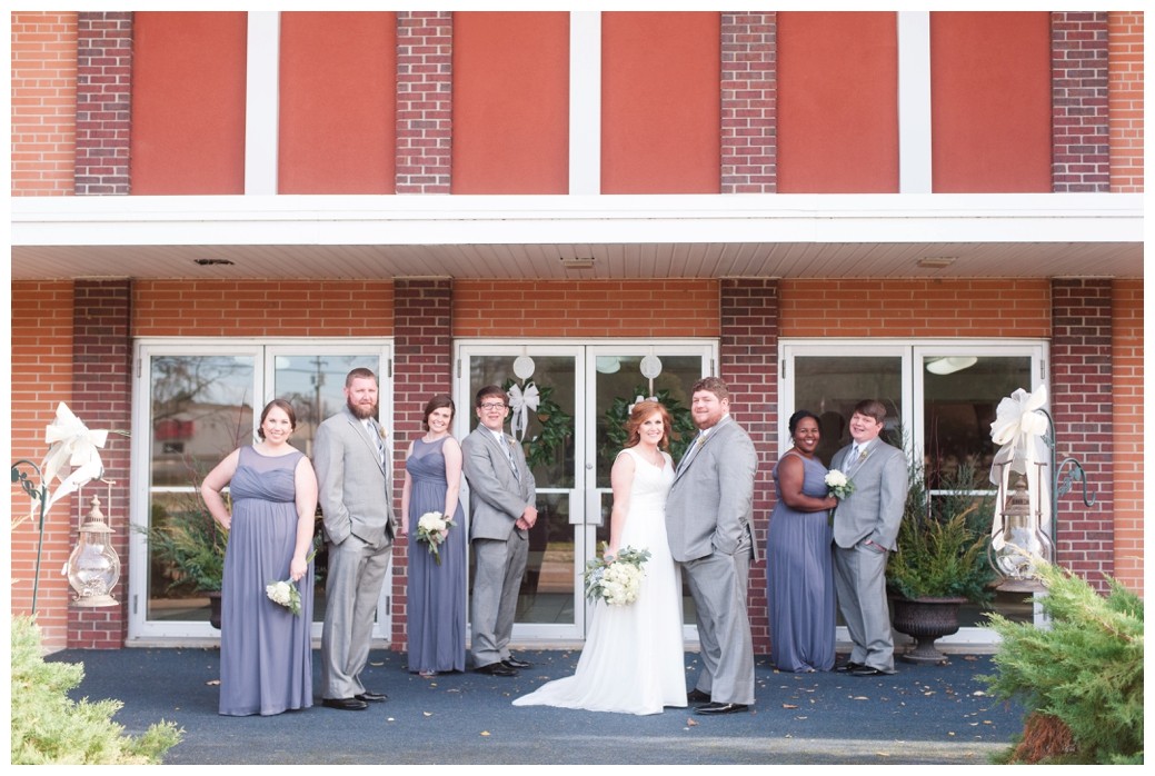 wedding party with blue grey dresses in front of church