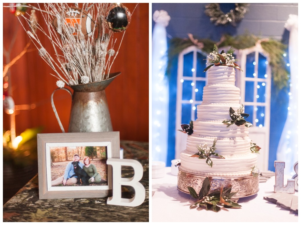 reception decoration of picture and B and wedding cake with greenery and blue background