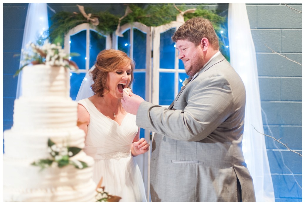 groom feeding bride wedding cake