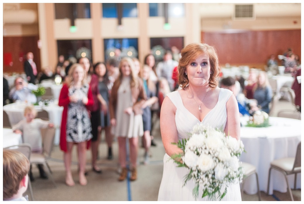 bride getting ready to throw bouquet to single girls standing behind her