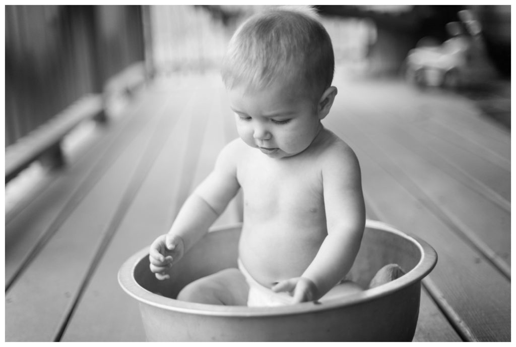 six month session naked baby in dishpan