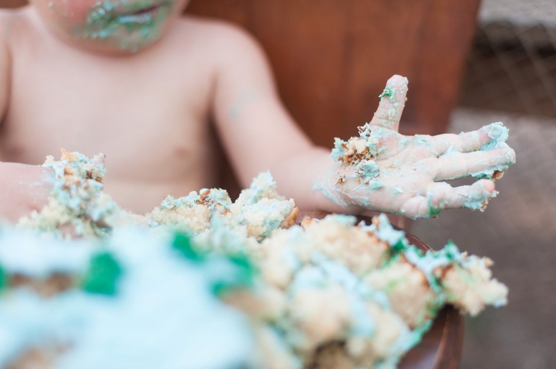 first birthday party hand in cake