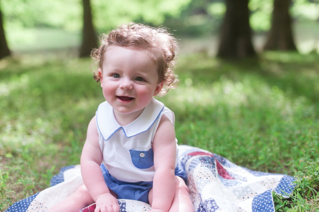 six-month-old portrait curly haired boy