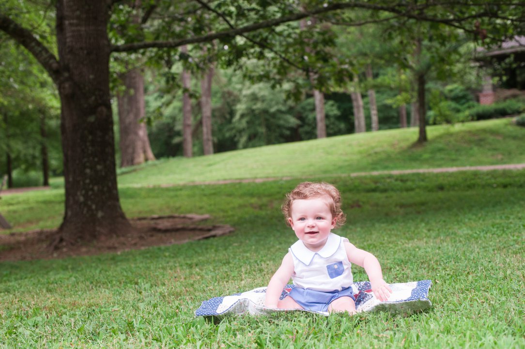 six-month-old portrait little boy under trees