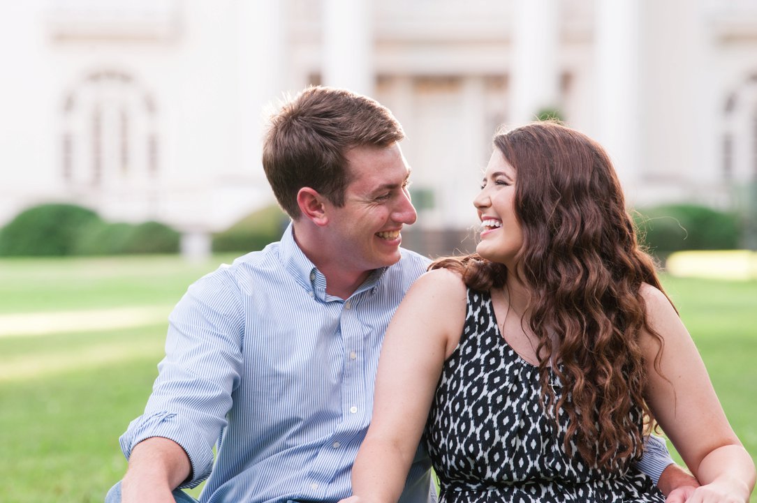 First Presbyterian Jackson engagement couple laughing sitting on grass