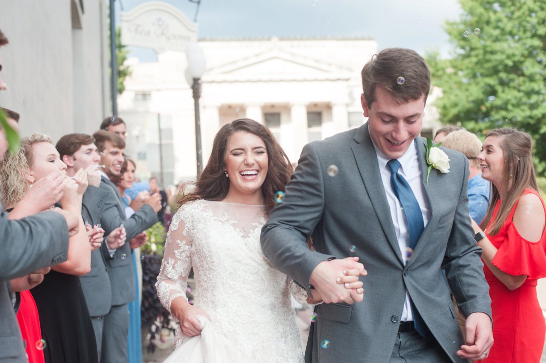 The colonial tea room bride and groom leaving in bubbles