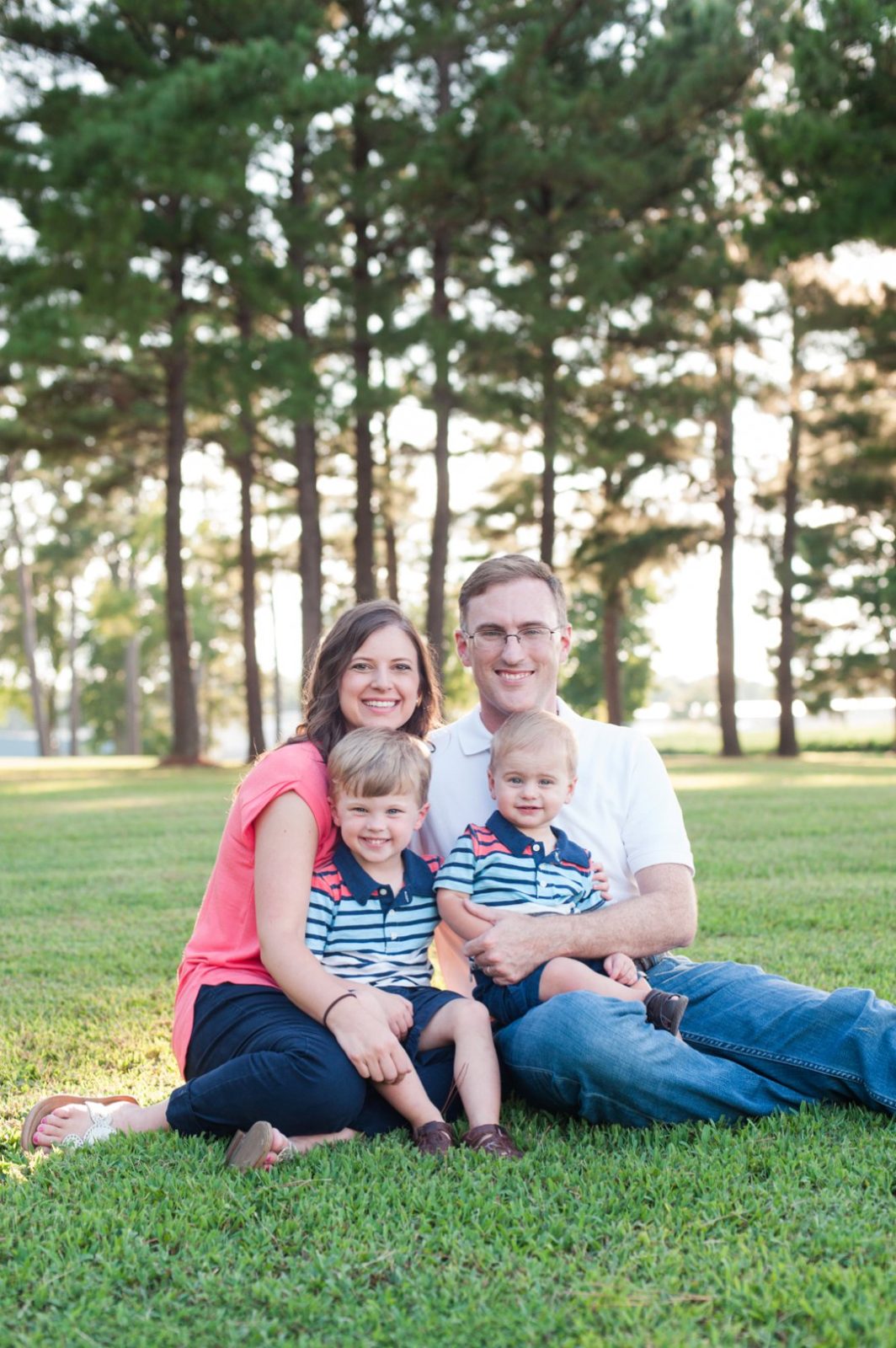 Pine Hill Park Spencer family sitting on ground in front of trees