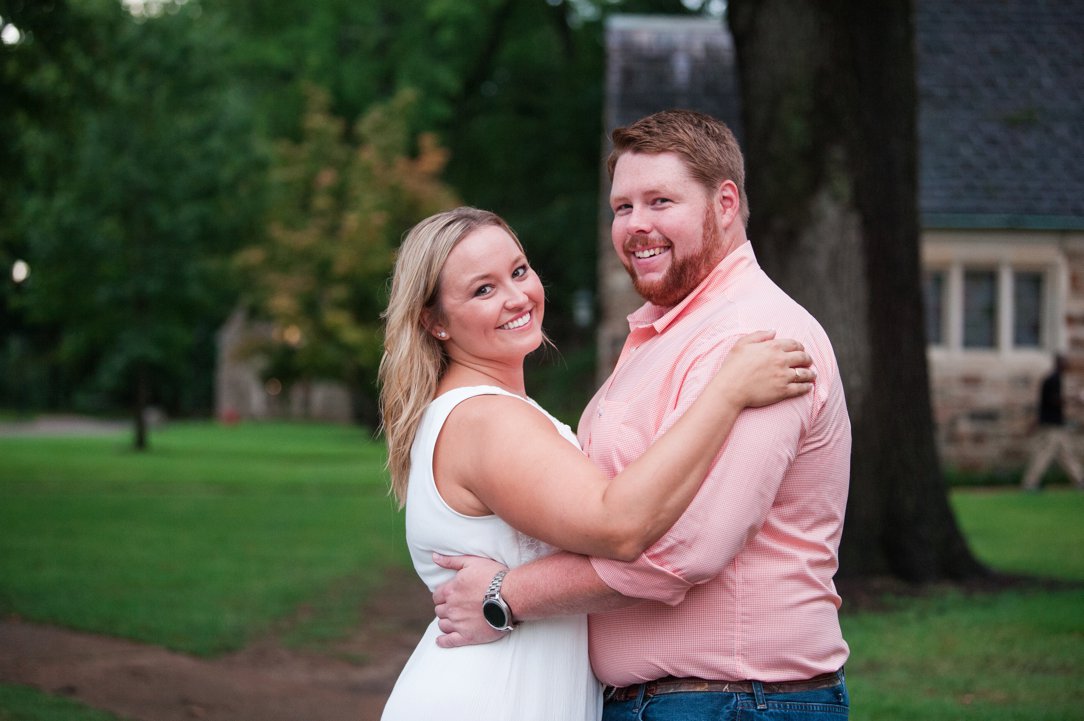 Rhodes College Engagement hugging in front of trees