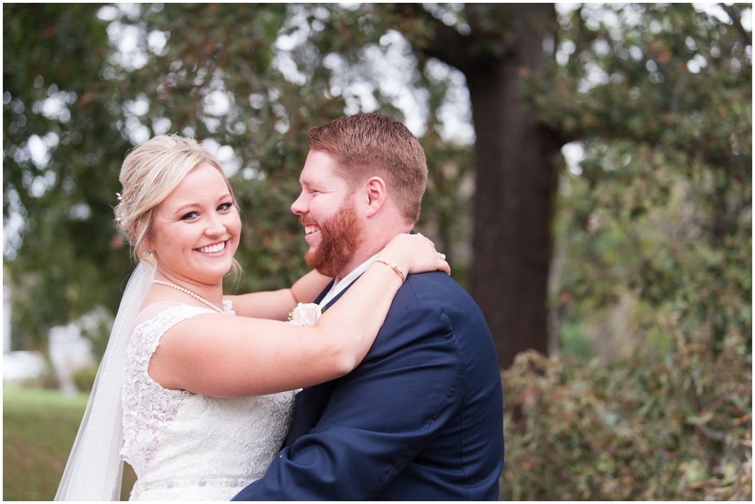 The Venue at Waddell Place bride looking at camera and groom