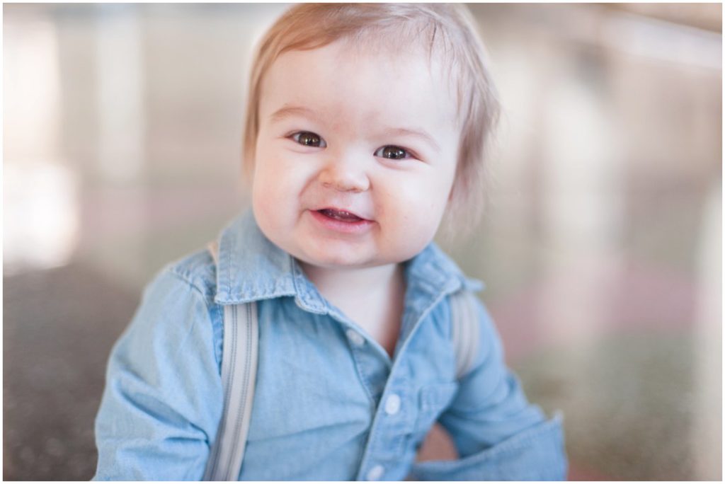 The New Southern portrait session little boy smiling in blue shirt and suspenders