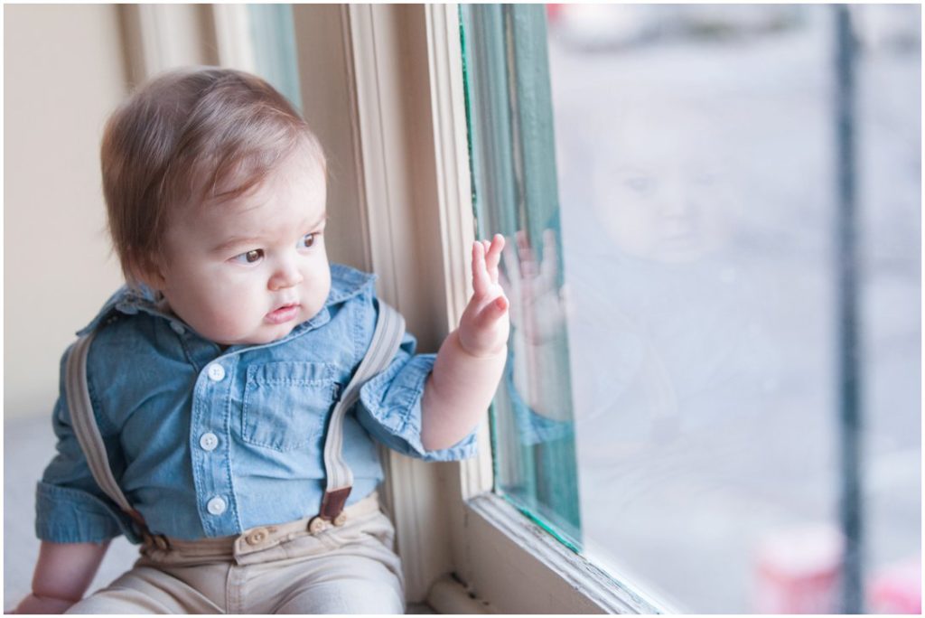 The New Southern portrait session little boy looking at reflection in glass