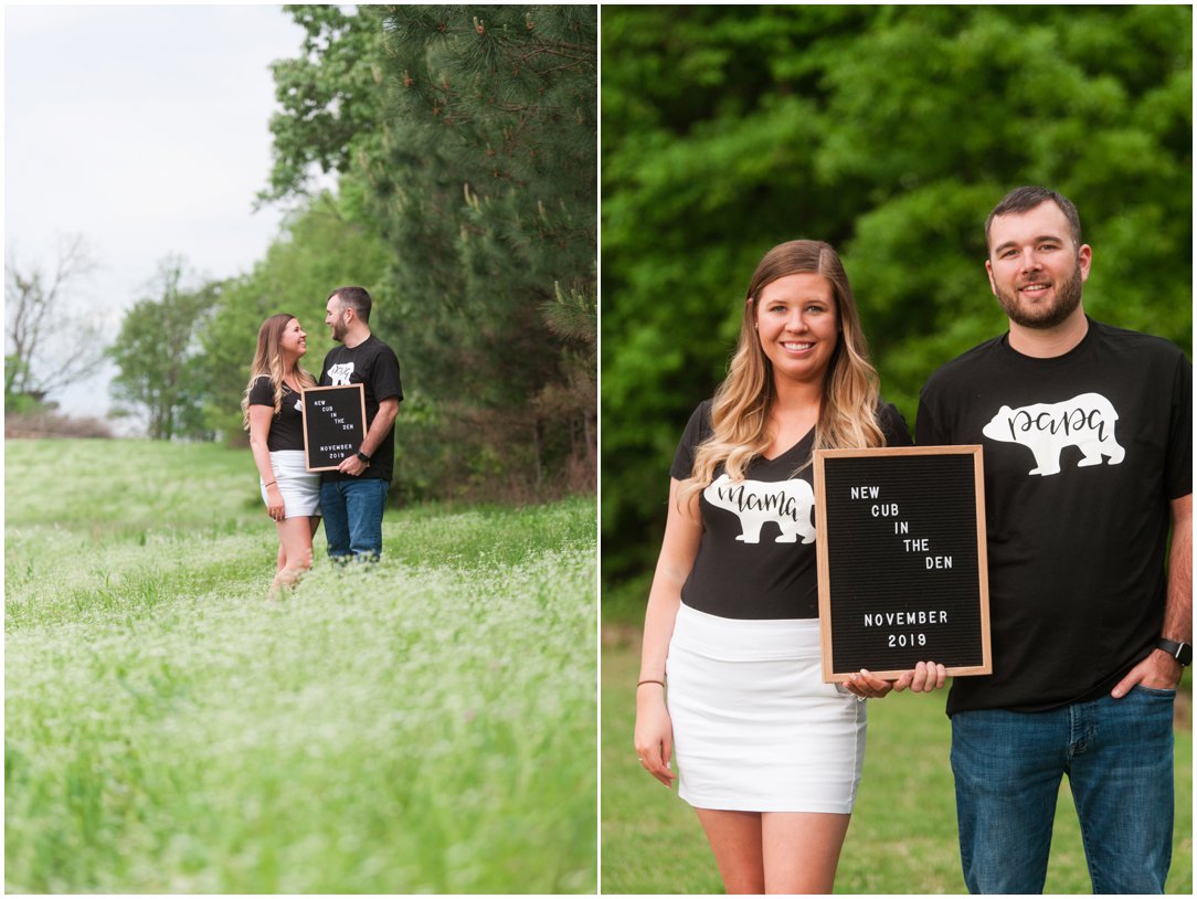 baby announcement couple in field with sign