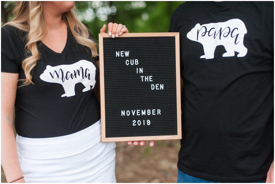 baby announcement holding sign with bear shirts