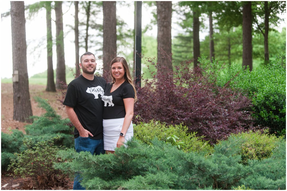 baby announcement couple in bushes