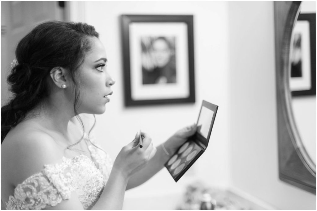 Outdoor Spring Wedding bride putting on makeup