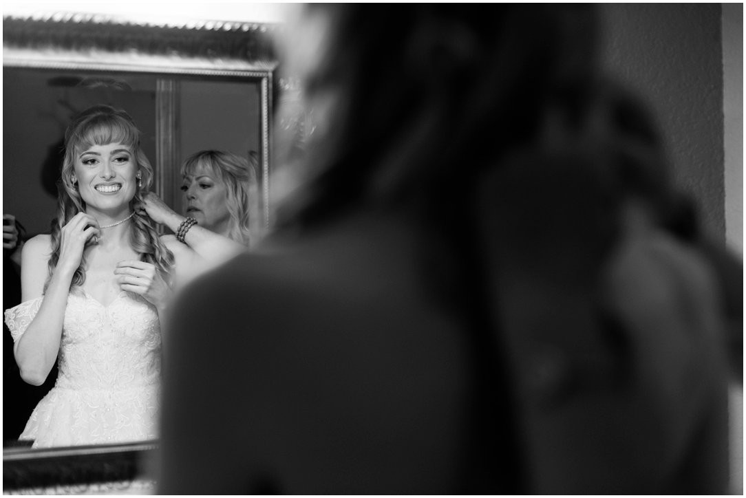 Summer lakeside Wedding bride looking in mirror