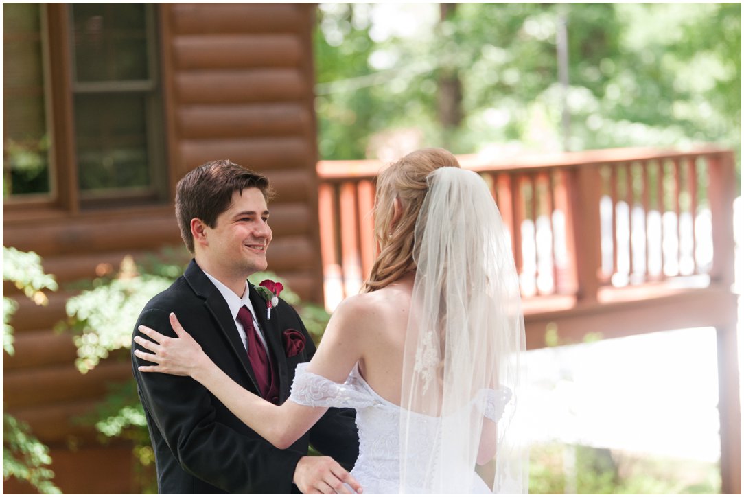 Summer lakeside Wedding groom seeing bride