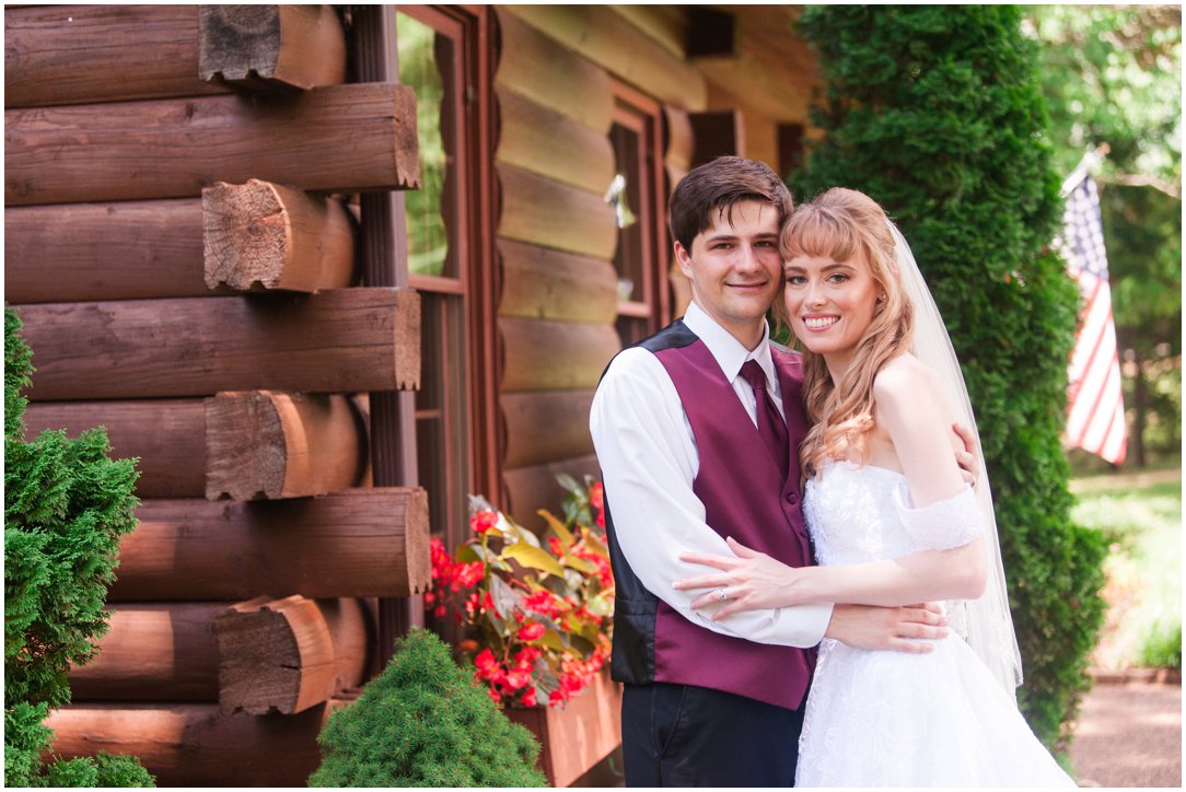 Summer lakeside Wedding couple by cabin