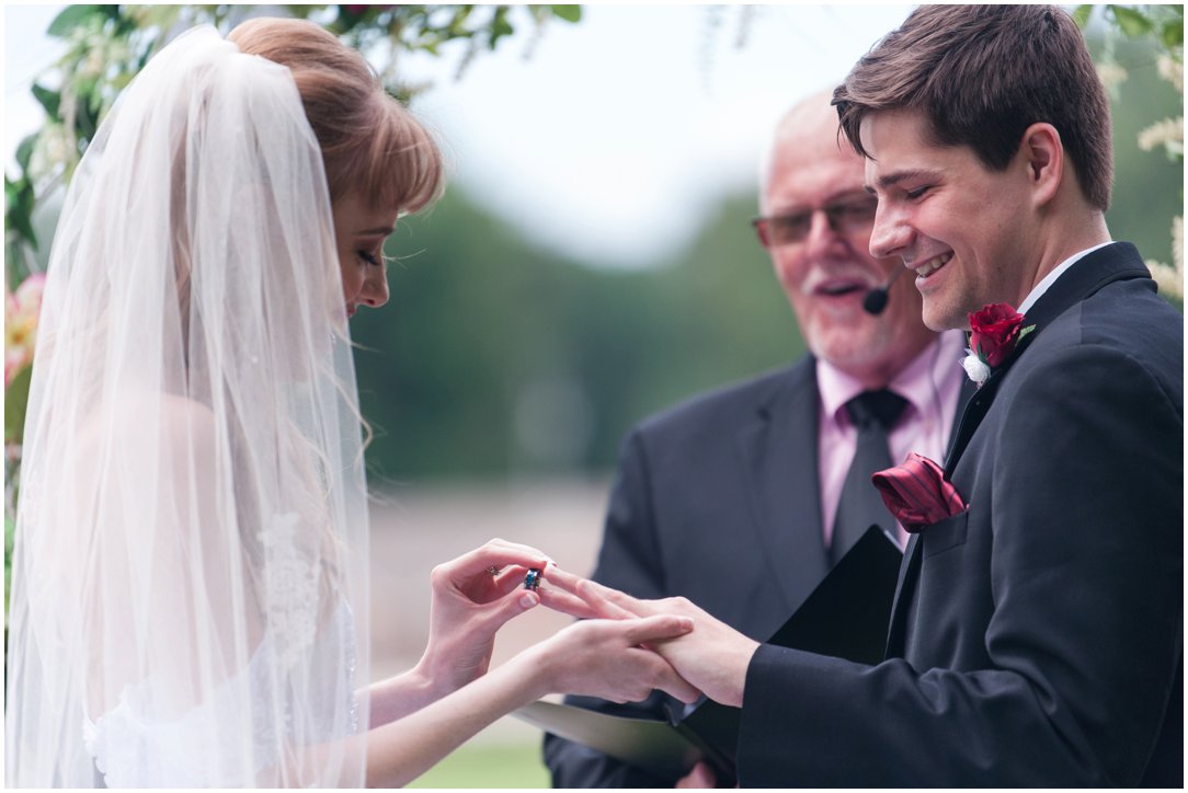 Summer lakeside Wedding exchanging rings