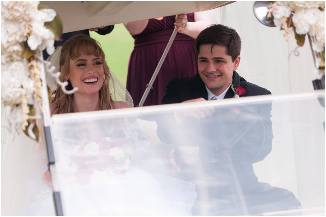 Summer lakeside Wedding bride and groom in golfcart