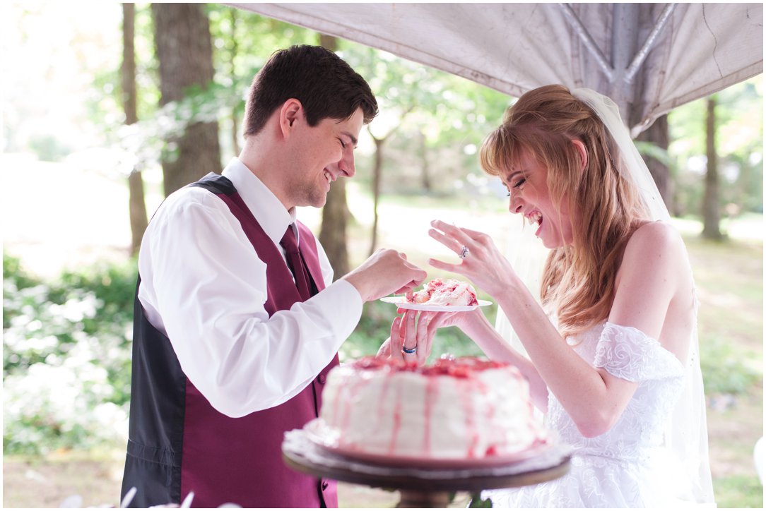 Summer lakeside Wedding couple with cake