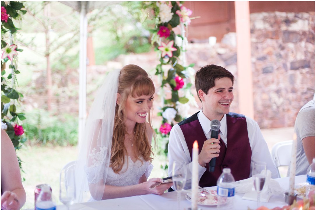 Summer lakeside Wedding couple giving toast