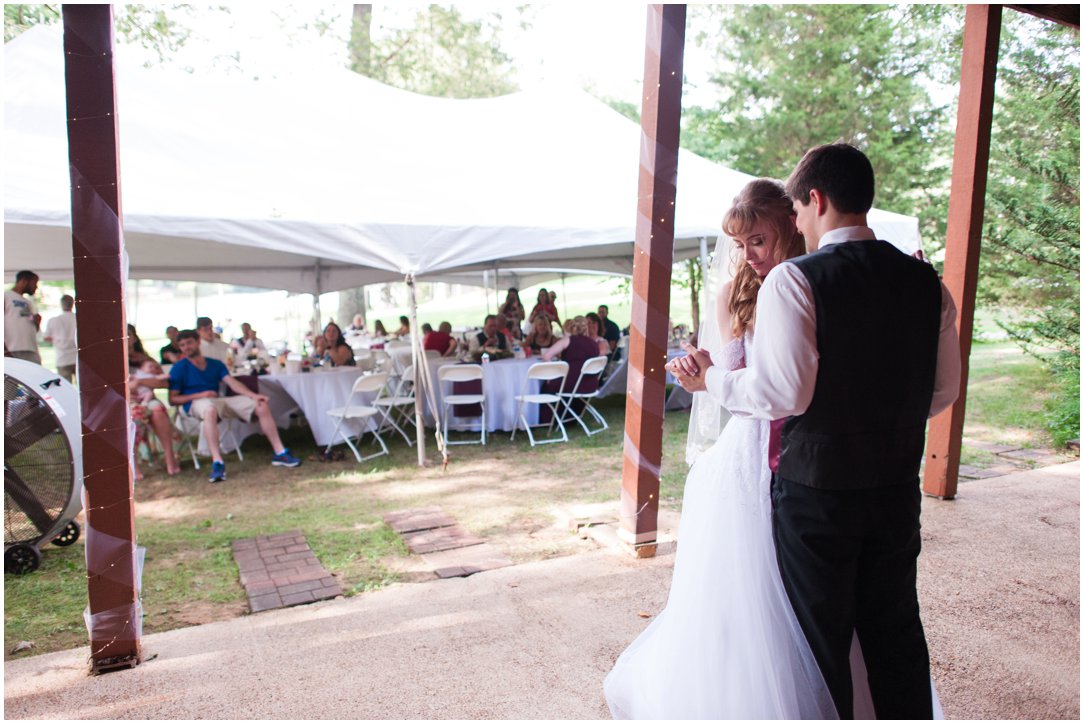 Summer lakeside Wedding couple dancing in front of guests