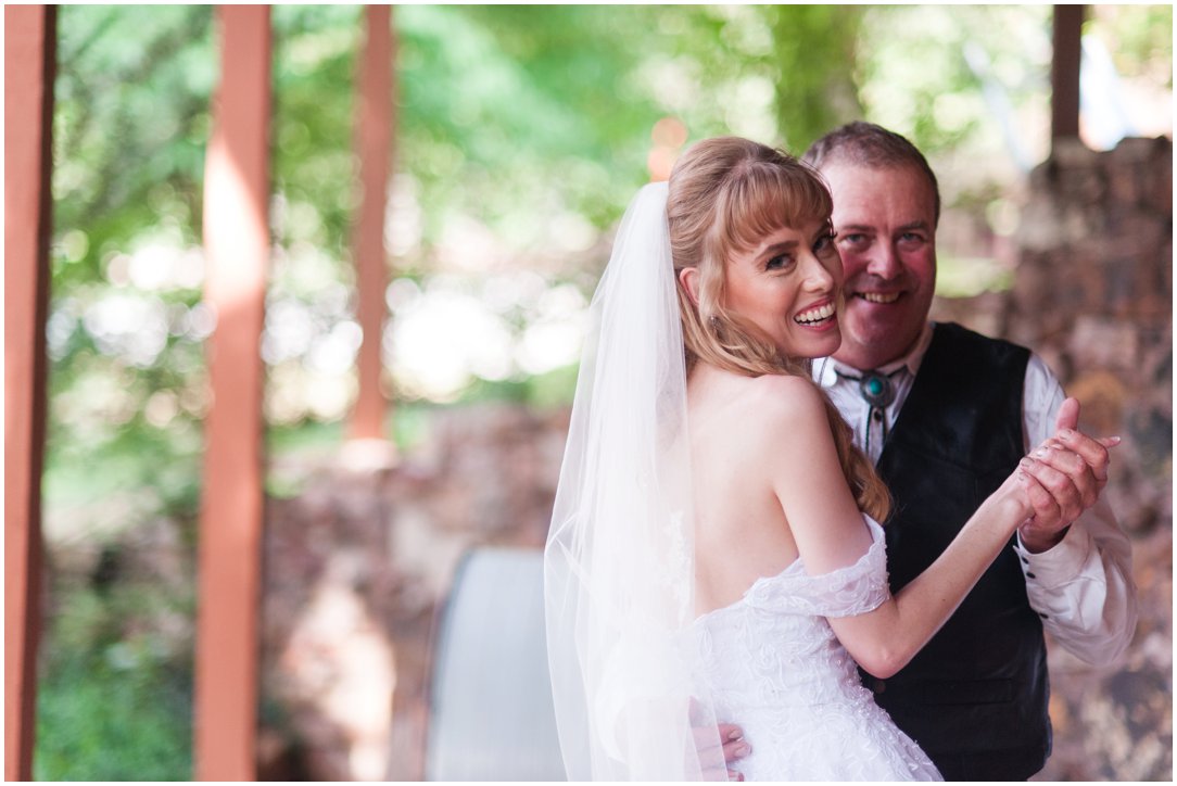 Summer lakeside Wedding bride and father laughing