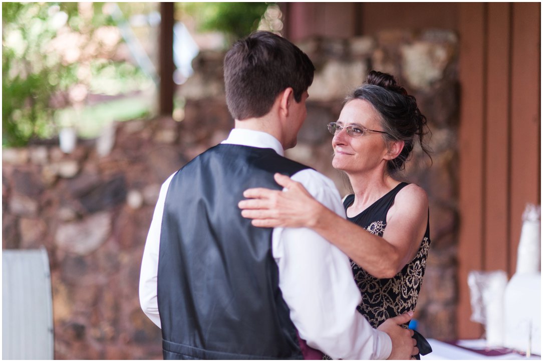 Summer lakeside Wedding groom dancing with mom