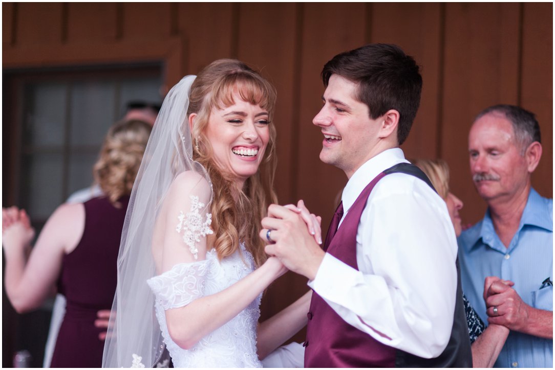 Summer lakeside Wedding couple laughing dancing