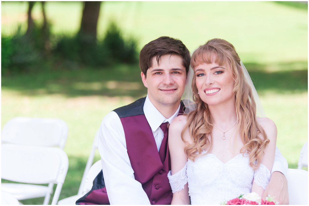 Summer lakeside Wedding bride and groom sitting