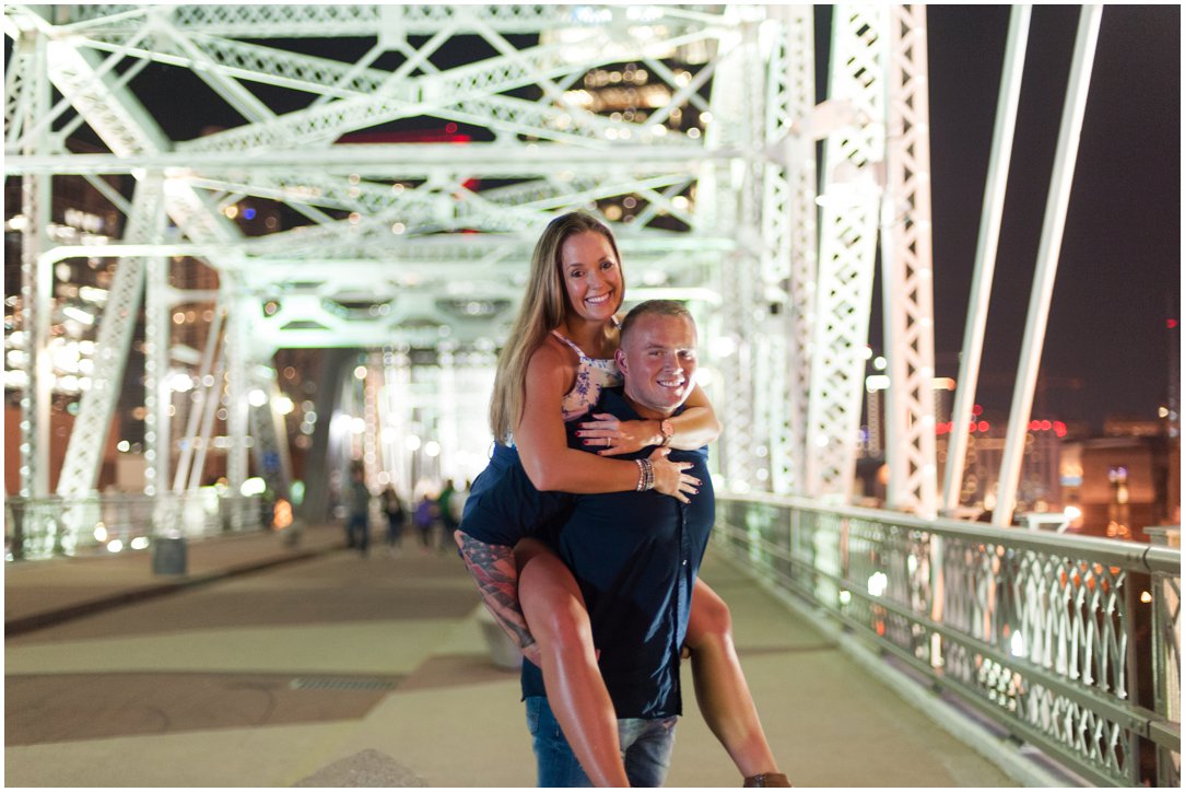 woman on mans back on Nashville Pedestrian Bridge