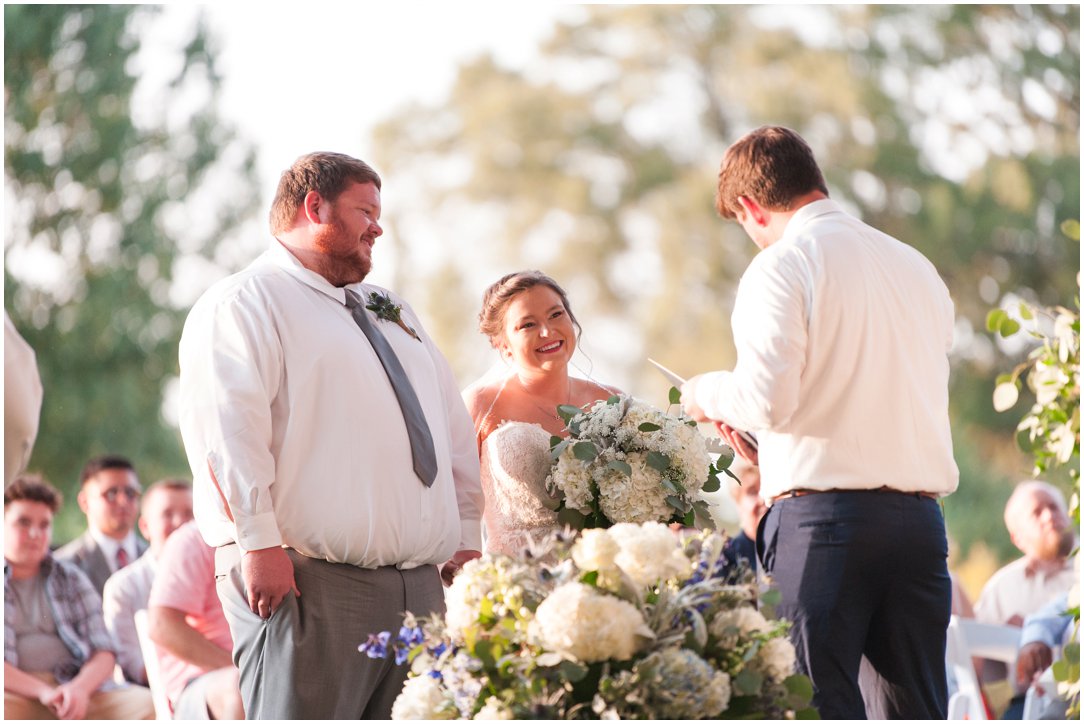 bride and groom laughing with pastor