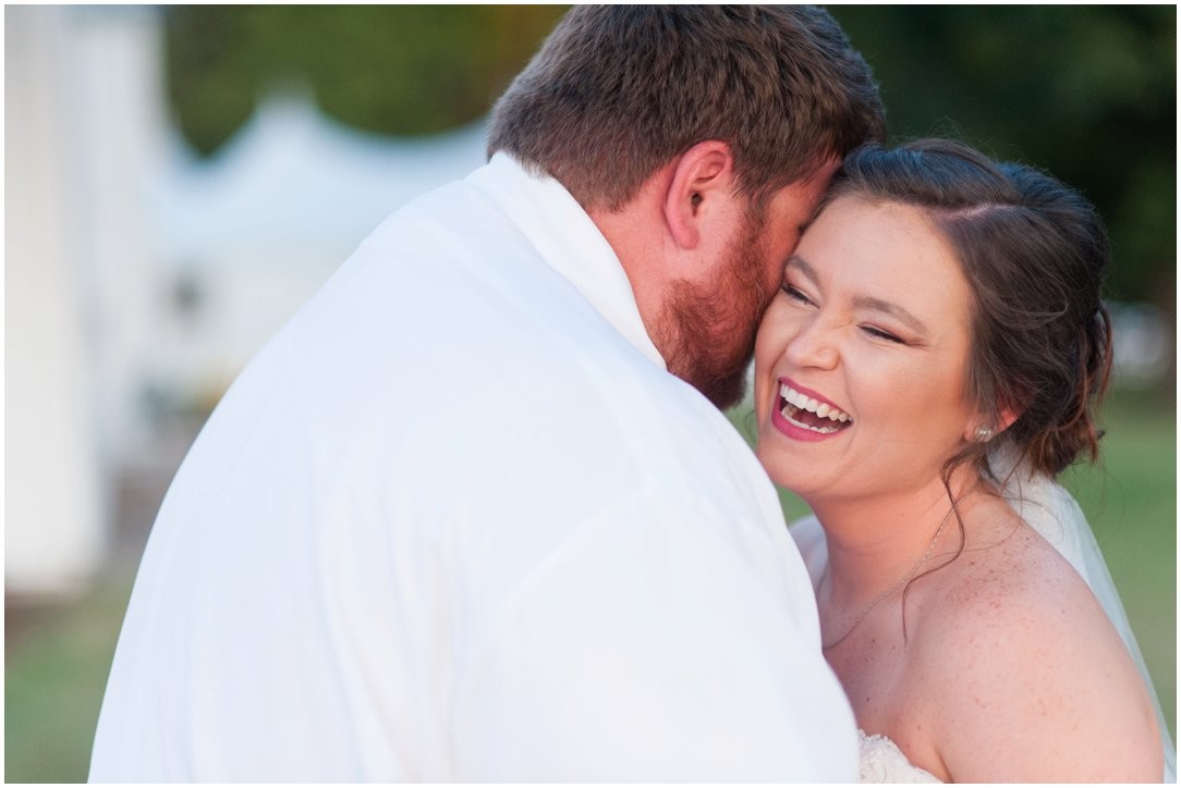 groom whispering in brides ear