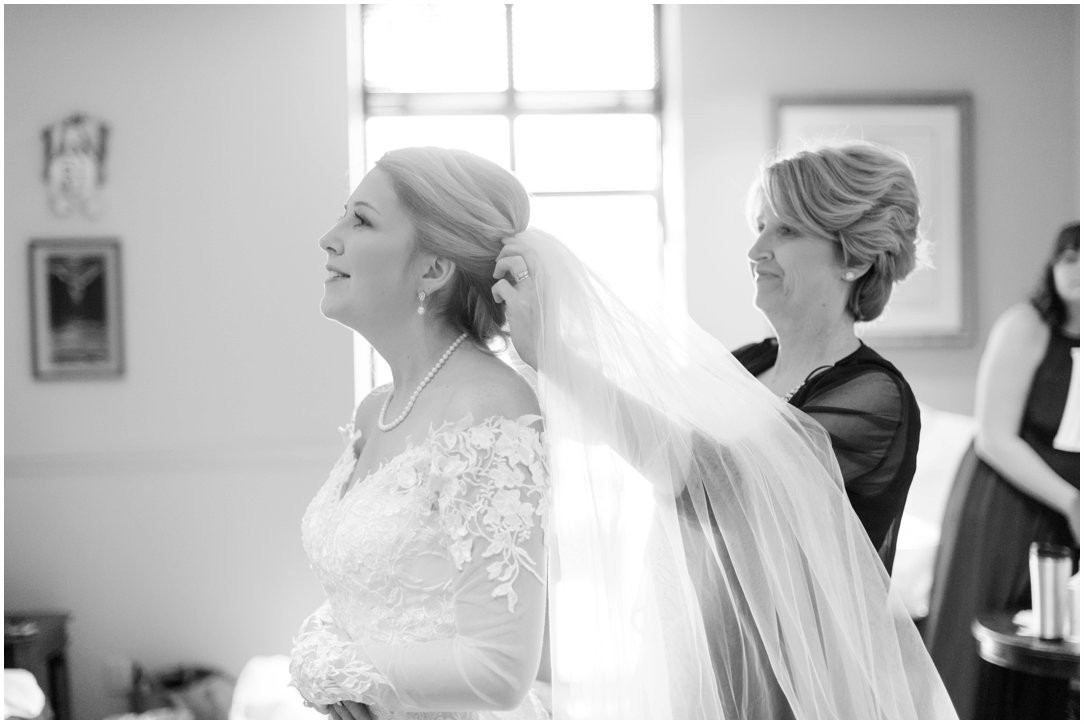 mother of bride putting on veil