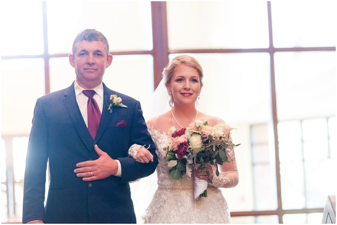 bride coming down aisle with father