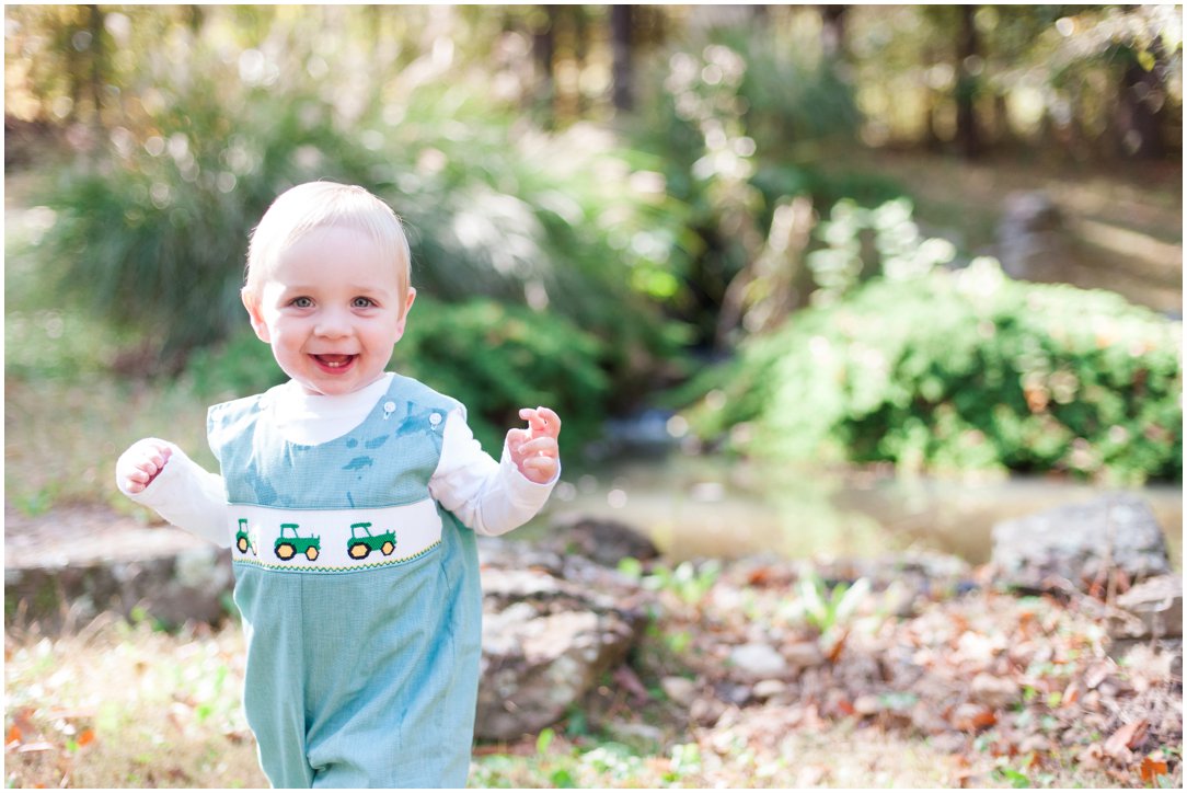 little boy smiling by water