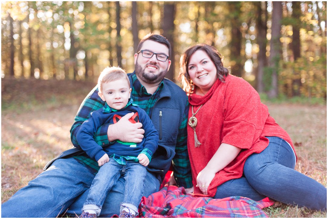 mom and dad and little boy on blanket