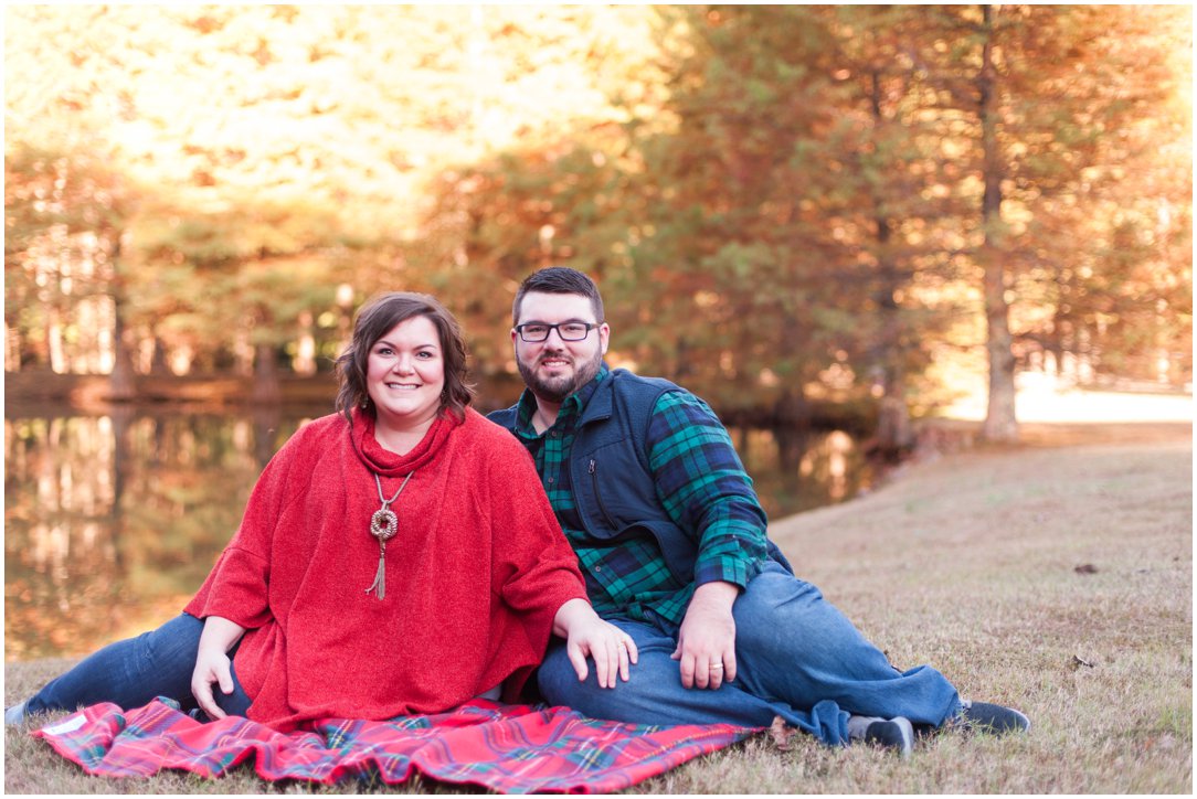 husband and wife on blanket by pond