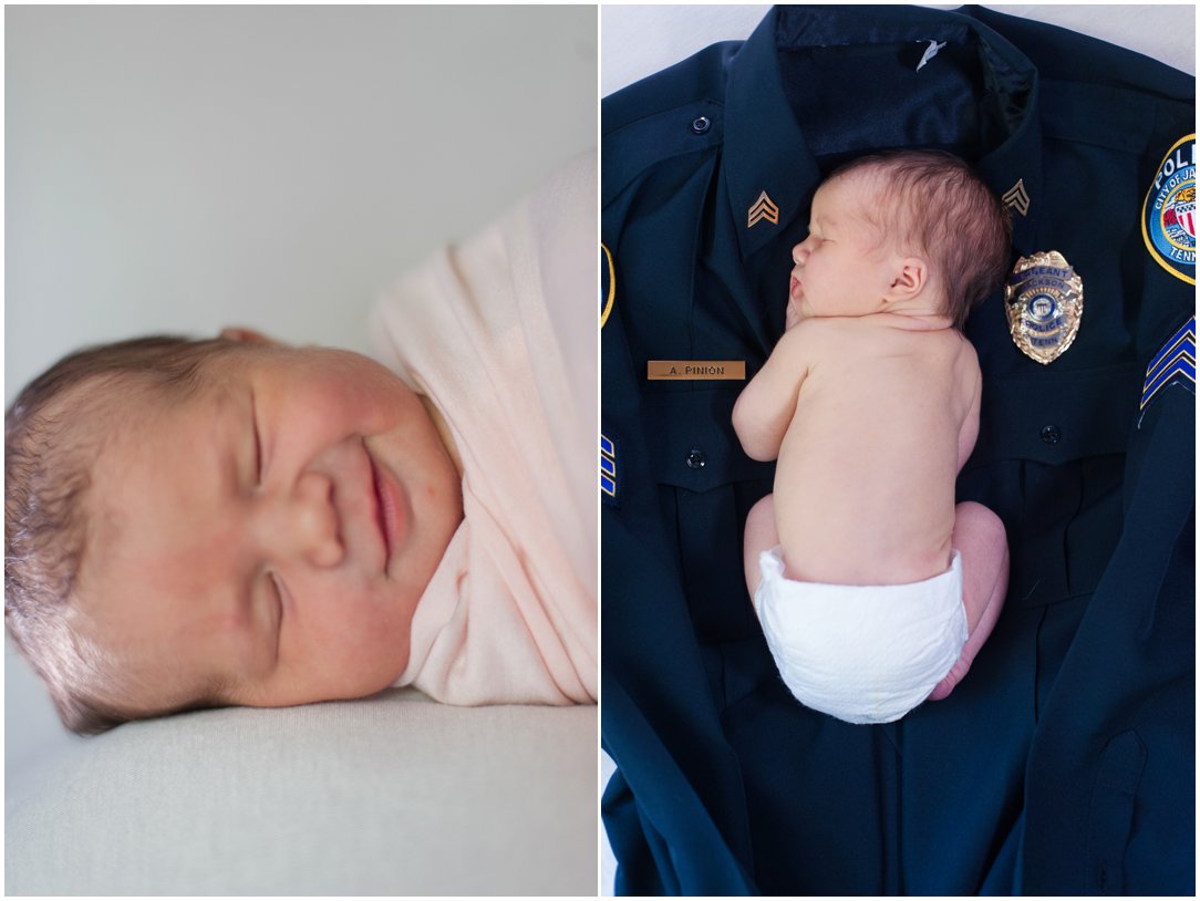 Charleigh's newborn session smiling laying on police uniform