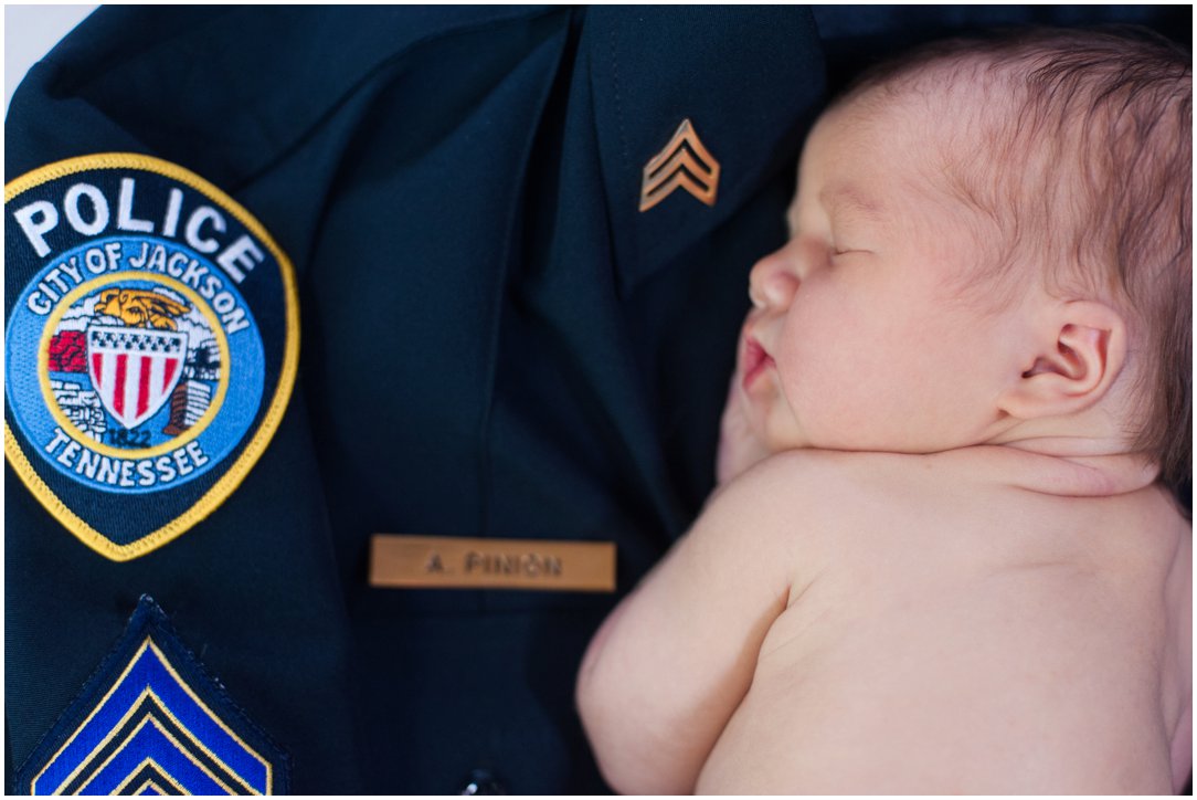 newborn on police uniform