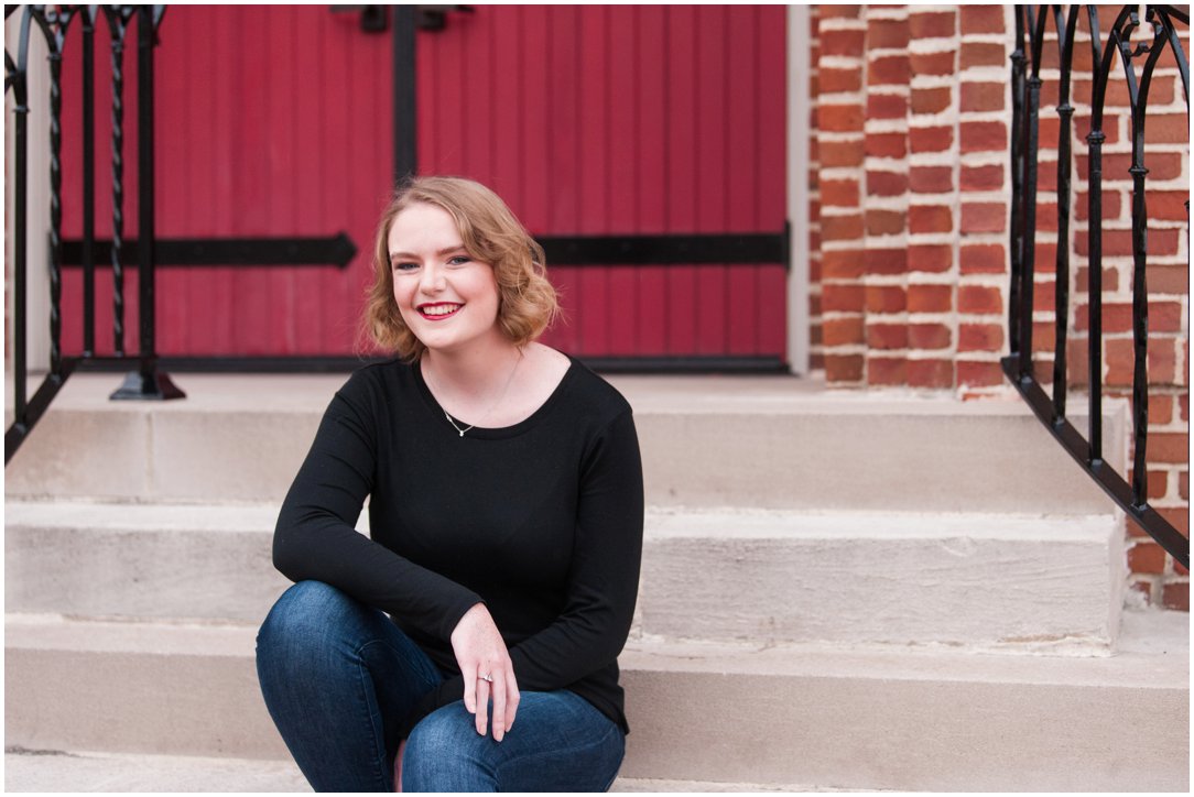 high school senior in front of red door