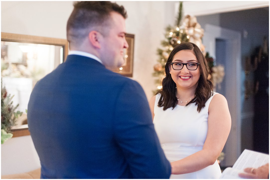 bride smiling in front of Christmas tree