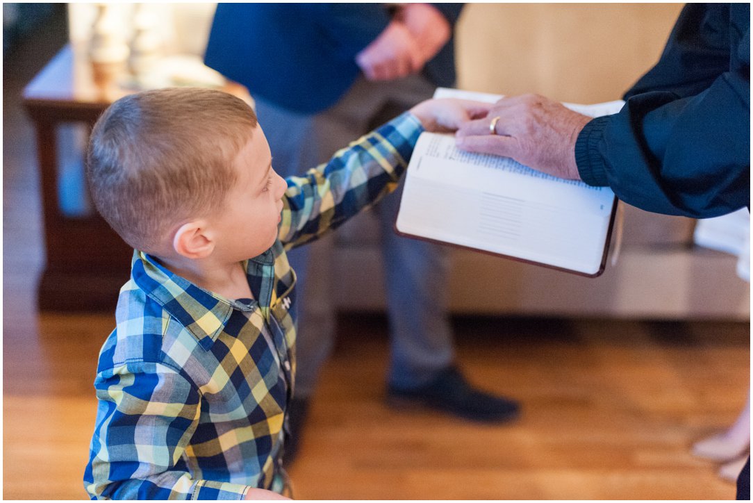 boy handing rings to officiant