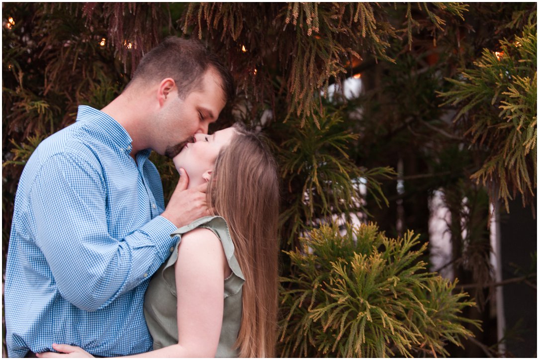 couple kissing in front of tree