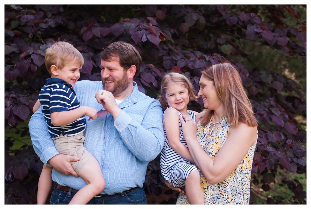 family in front of purple tree